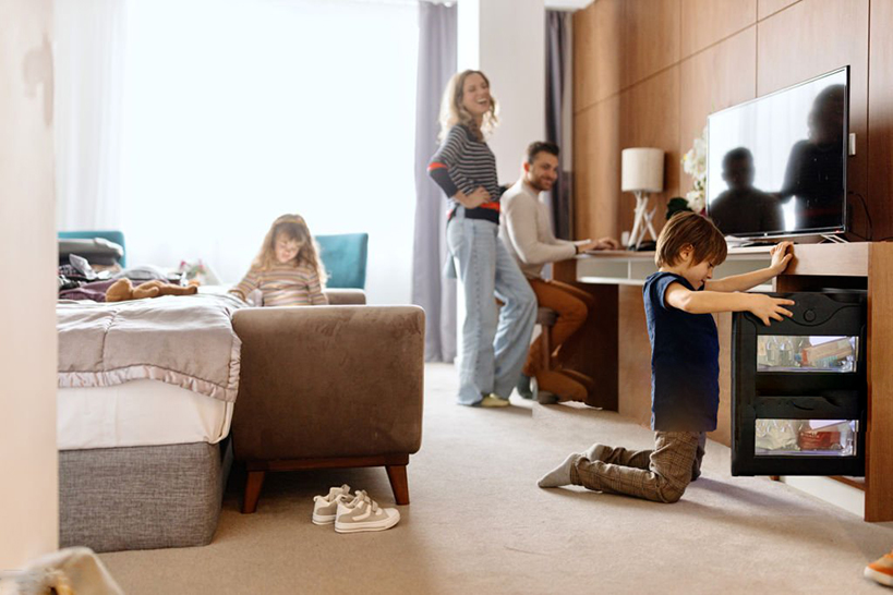 Child opening minibar in hotel room
